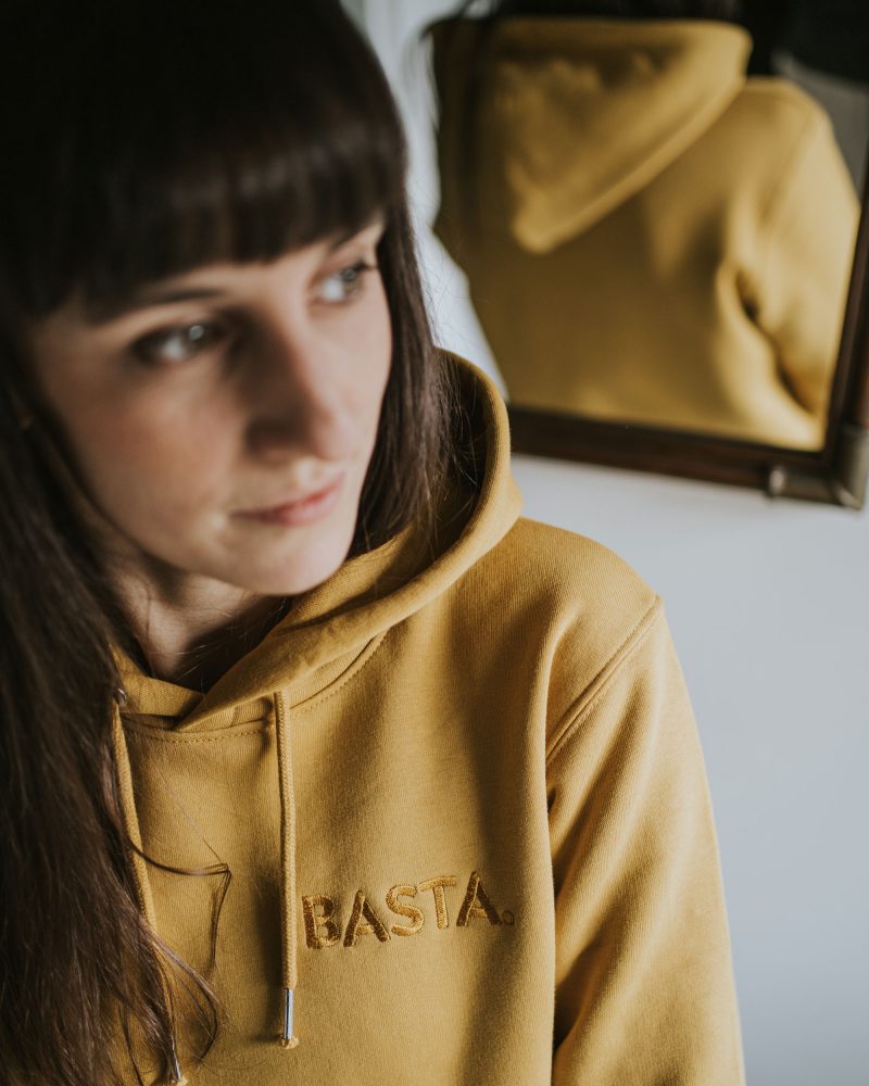 woman wearing Basta hoodie in ochre