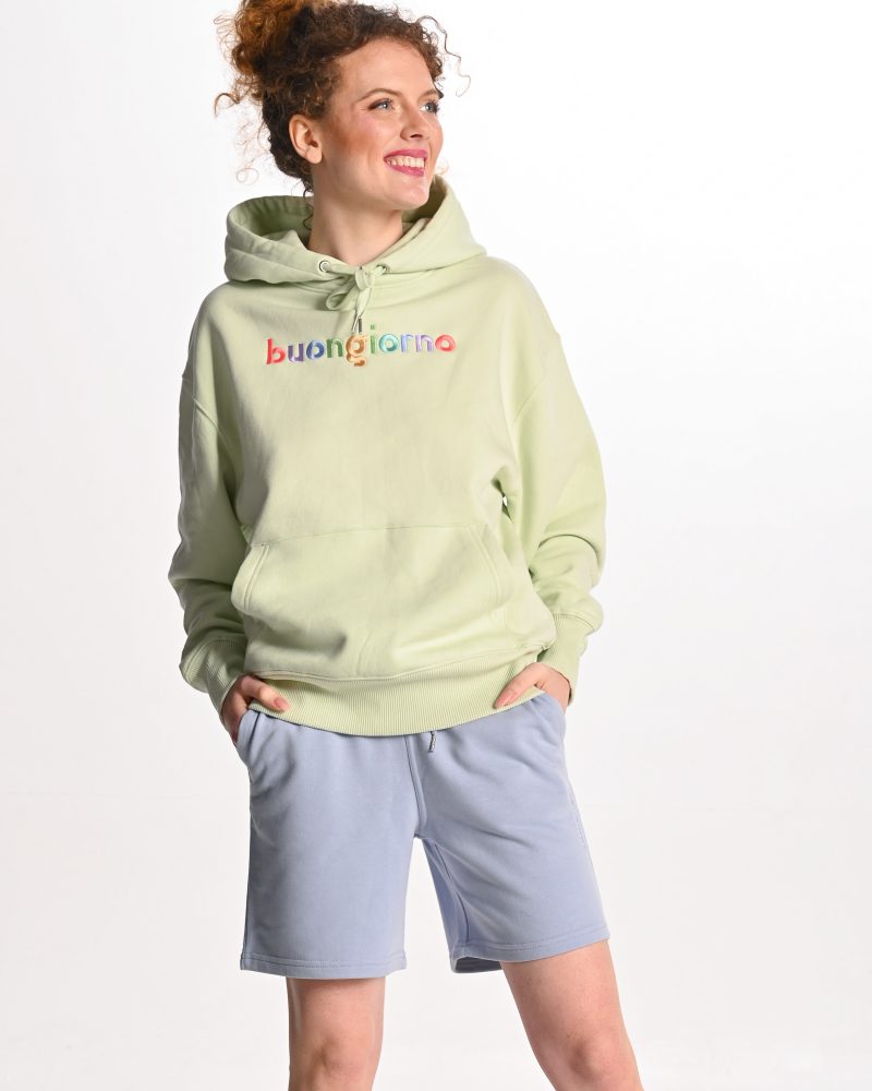 woman wearing light green buongiorno hoodie and blue short sweatpants
